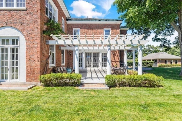 rear view of house featuring a pergola, french doors, a lawn, and a patio