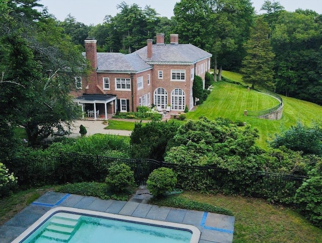 view of pool featuring a lawn and french doors