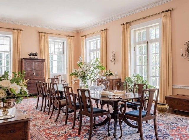 dining space with crown molding