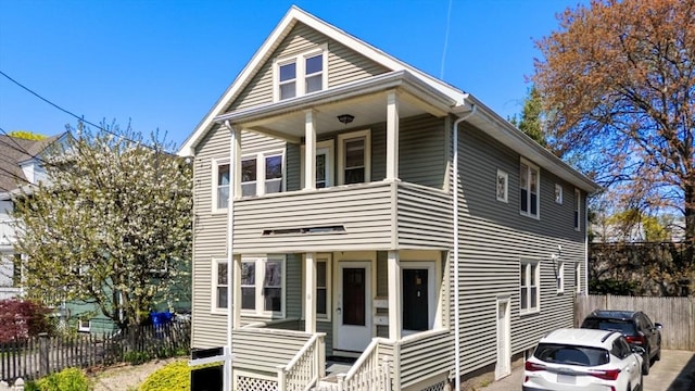 multi unit property featuring a balcony and fence