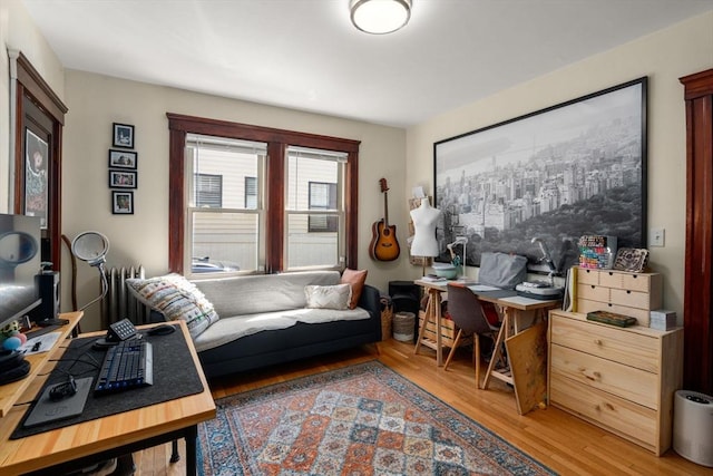 office space featuring light wood-style floors and radiator