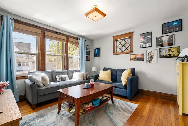 living area featuring wood-type flooring and baseboards