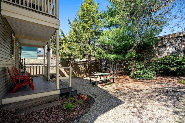 view of yard with fence and a deck