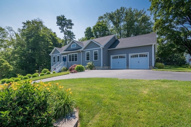 3 Ethan Cir, South Hadley, MA 01075 - view of front of home with driveway, an attached garage, and a front yard