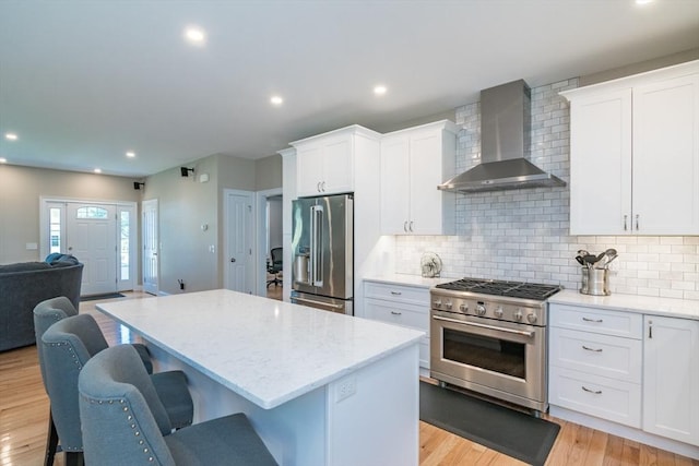 3 Ethan Cir, South Hadley, MA 01075 - kitchen featuring wall chimney exhaust hood, high end appliances, a kitchen island, light stone countertops, and recessed lighting