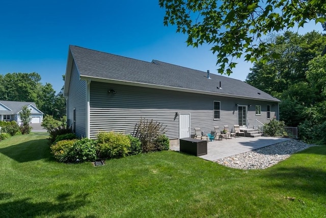 3 Ethan Cir, South Hadley, MA 01075 - rear view of property with a patio, a lawn, and roof with shingles