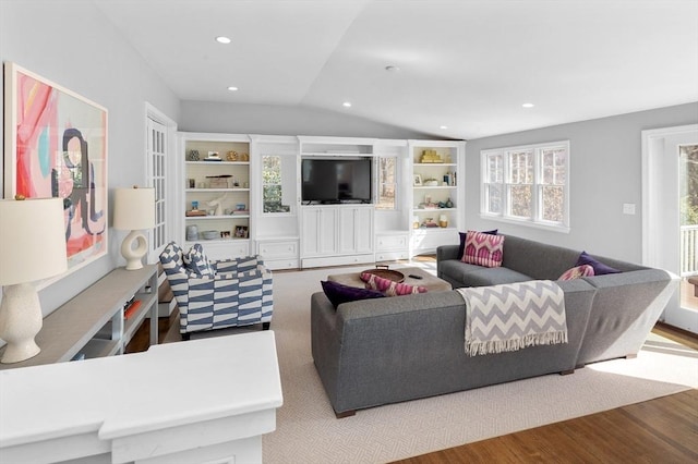 living room with recessed lighting, lofted ceiling, and wood finished floors