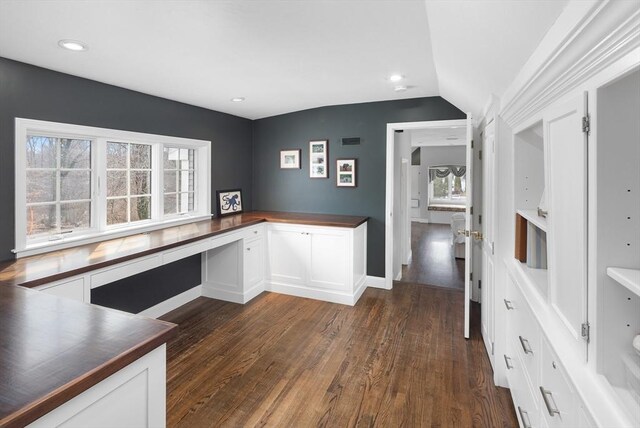 kitchen with plenty of natural light, built in desk, and white cabinetry