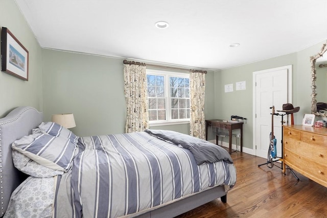 bedroom featuring wood finished floors and baseboards