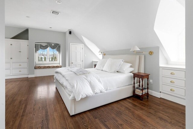 bedroom with visible vents, dark wood-type flooring, baseboards, and vaulted ceiling