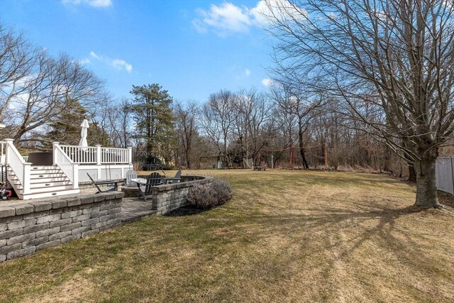 view of yard with a wooden deck and stairs