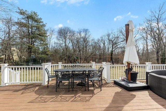 wooden deck featuring outdoor dining area