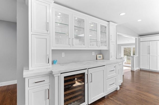 bar featuring recessed lighting, dark wood-style floors, baseboards, and beverage cooler