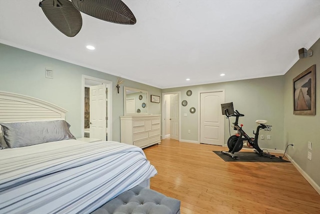 bedroom featuring ornamental molding, recessed lighting, light wood-style flooring, and baseboards