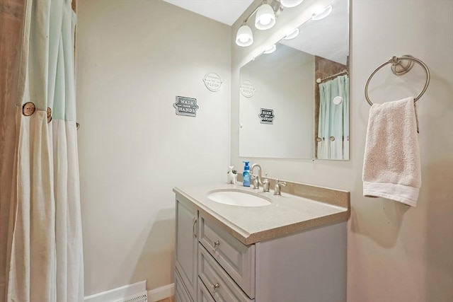 full bath with baseboards and vanity