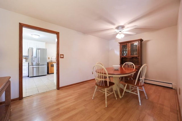 439 S St Unit A, Plainville, MA 02762 - dining space featuring a baseboard heating unit, a ceiling fan, and light wood-style floors