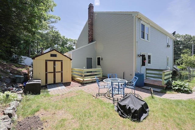 439 S St Unit A, Plainville, MA 02762 - back of house with a storage shed, a deck, a chimney, a yard, and a patio