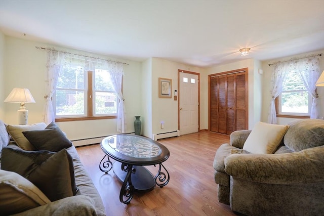 439 S St Unit A, Plainville, MA 02762 - living area featuring baseboard heating, plenty of natural light, and wood finished floors