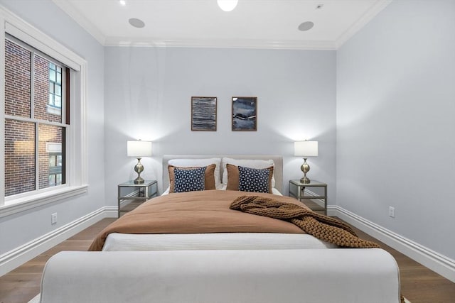 bedroom with dark wood-type flooring, ornamental molding, and multiple windows