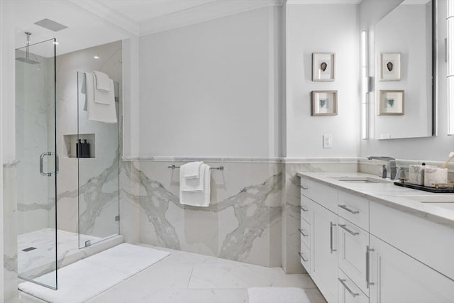 bathroom with an enclosed shower, vanity, tile walls, and ornamental molding