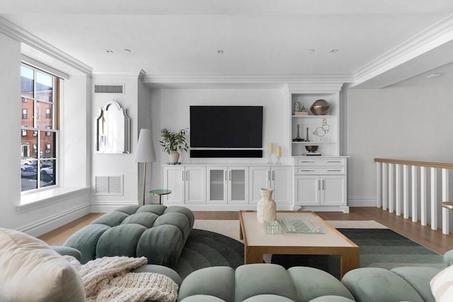 living room with crown molding and hardwood / wood-style flooring