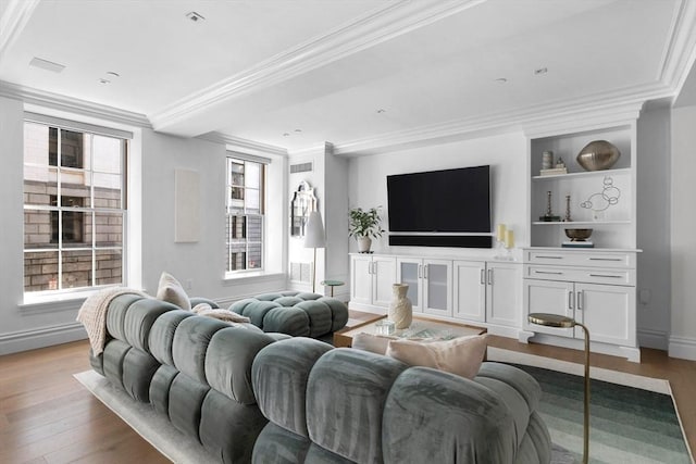 living room with light wood-type flooring and crown molding