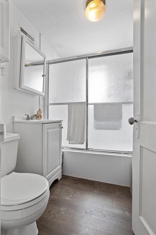 28 Gardner St, Arlington, MA 02474 - bathroom featuring shower / bath combination with glass door, wood finished floors, and toilet