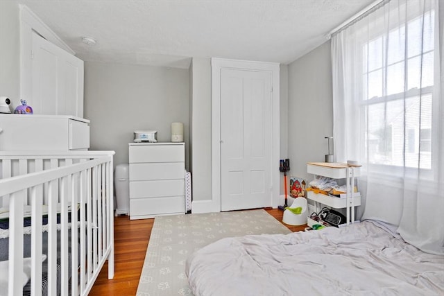 28 Gardner St, Arlington, MA 02474 - bedroom featuring wood finished floors and a textured ceiling