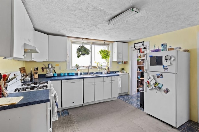 28 Gardner St, Arlington, MA 02474 - kitchen featuring white appliances, a sink, under cabinet range hood, dark countertops, and white cabinets