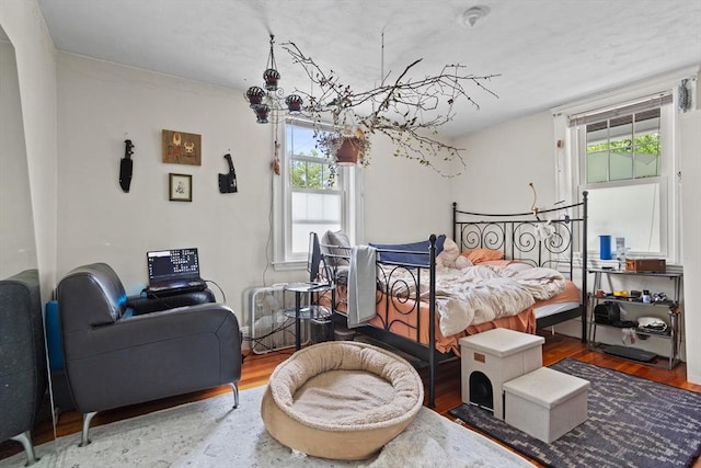 28 Gardner St, Arlington, MA 02474 - bedroom with multiple windows, wood finished floors, and a chandelier