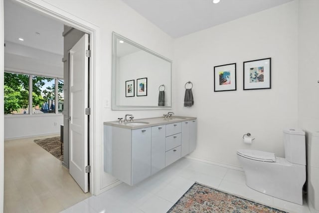62 Pearl Unit 62, Cambridge, MA 02139 - bathroom with double vanity, toilet, recessed lighting, and baseboards