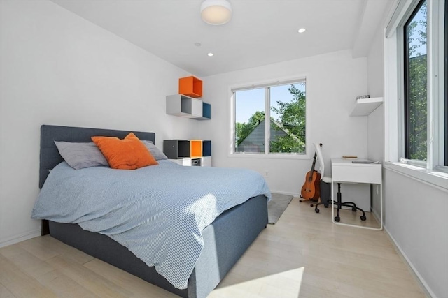 62 Pearl Unit 62, Cambridge, MA 02139 - bedroom featuring multiple windows, light wood-type flooring, baseboards, recessed lighting, and an office area