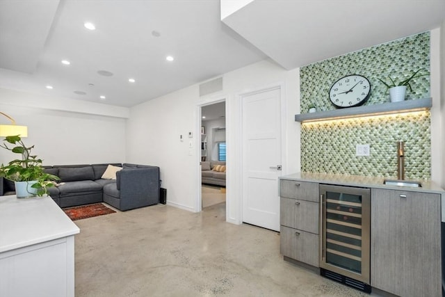 62 Pearl Unit 62, Cambridge, MA 02139 - indoor wet bar with wine cooler, finished concrete flooring, recessed lighting, decorative backsplash, and baseboards