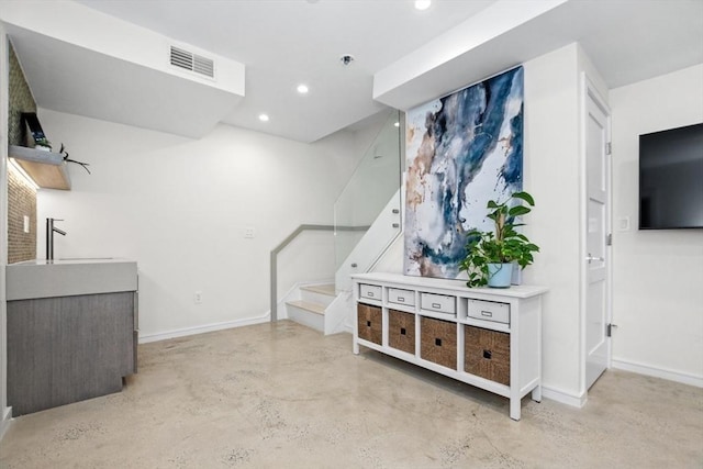 62 Pearl Unit 62, Cambridge, MA 02139 - below grade area featuring stairs, baseboards, and recessed lighting