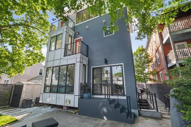 62 Pearl Unit 62, Cambridge, MA 02139 - rear view of property with cooling unit and a patio area