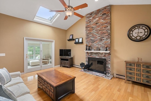 8 Brian Cir, Grafton, MA 01519 - living area featuring a ceiling fan, high vaulted ceiling, a skylight, a baseboard radiator, and wood finished floors