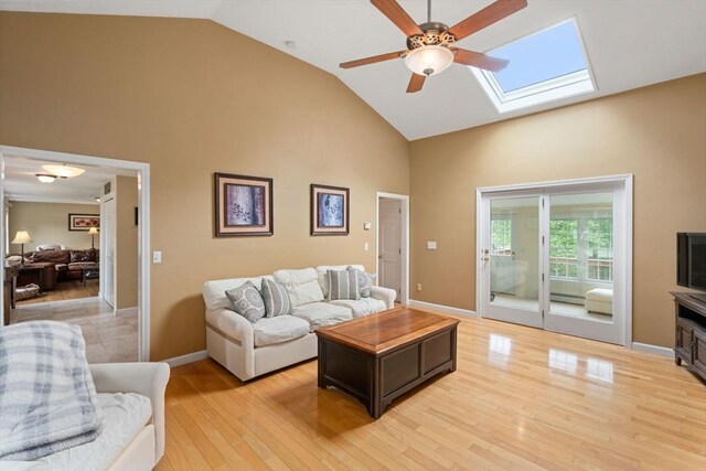 8 Brian Cir, Grafton, MA 01519 - living area featuring high vaulted ceiling, a skylight, ceiling fan, light wood finished floors, and baseboards