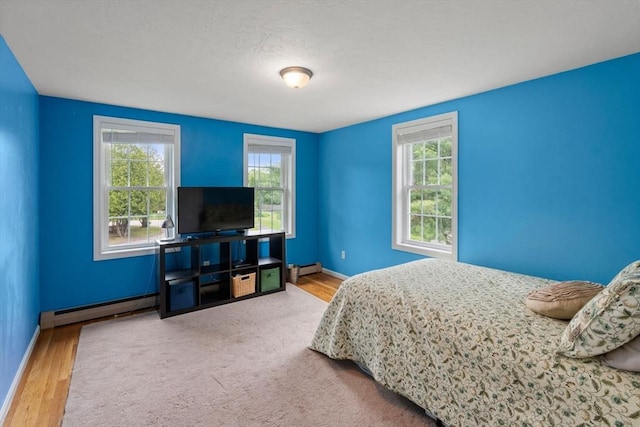 8 Brian Cir, Grafton, MA 01519 - bedroom featuring a baseboard radiator, baseboards, baseboard heating, and wood finished floors