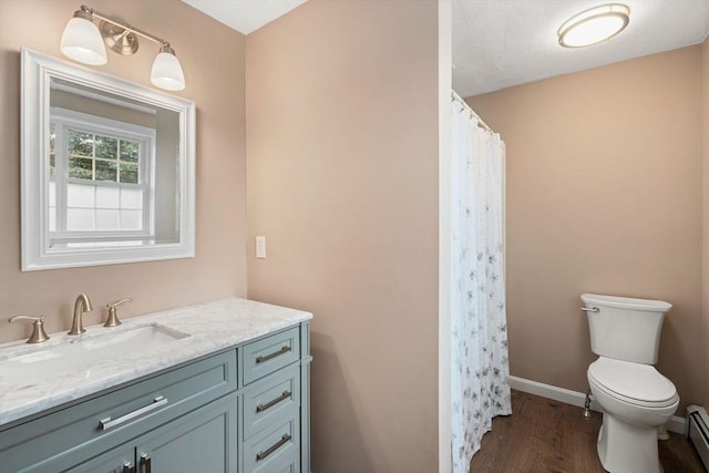 8 Brian Cir, Grafton, MA 01519 - bathroom featuring vanity, toilet, wood finished floors, baseboard heating, and baseboards