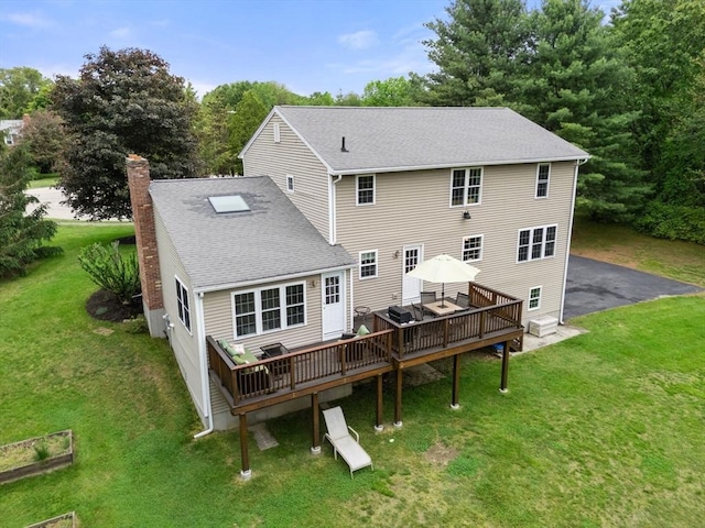 8 Brian Cir, Grafton, MA 01519 - back of property with a deck, a chimney, a shingled roof, and a lawn