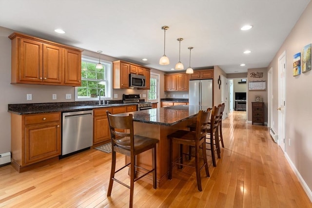 8 Brian Cir, Grafton, MA 01519 - kitchen with appliances with stainless steel finishes, a baseboard heating unit, a sink, brown cabinets, and recessed lighting