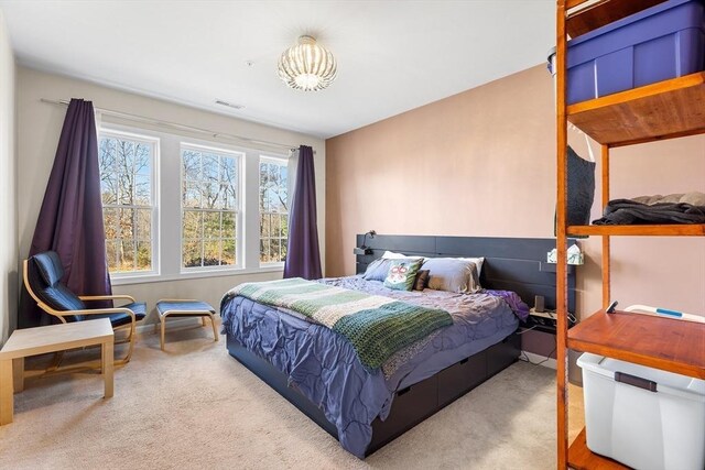 bedroom featuring light colored carpet