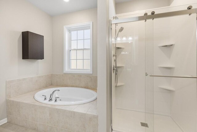 bathroom featuring independent shower and bath