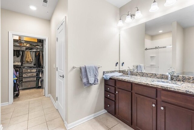 bathroom featuring tile patterned flooring and vanity