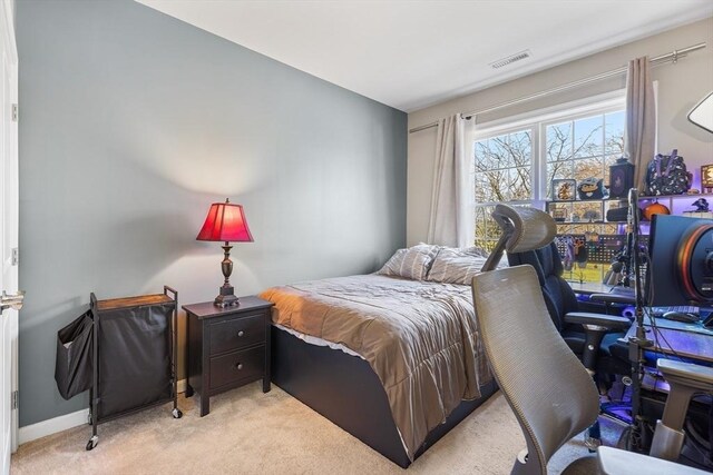 bedroom featuring light carpet