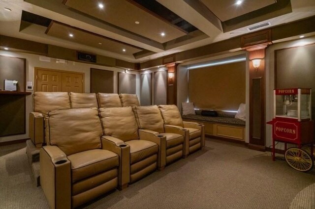 carpeted home theater room with decorative columns