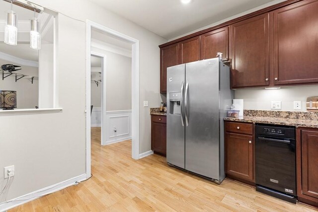 kitchen with light stone countertops, light wood-type flooring, ornamental molding, decorative light fixtures, and stainless steel fridge with ice dispenser