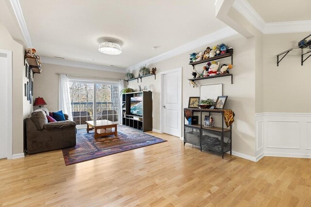 living room featuring light wood-type flooring and crown molding