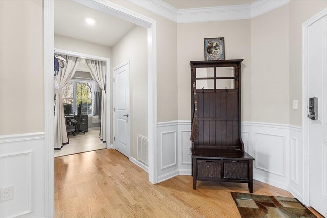 mudroom featuring crown molding and light hardwood / wood-style flooring