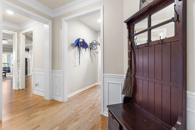 mudroom featuring light wood-type flooring and crown molding
